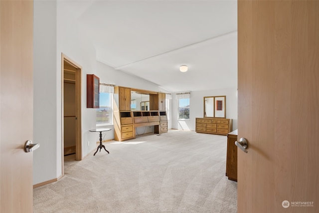 living area with vaulted ceiling and carpet