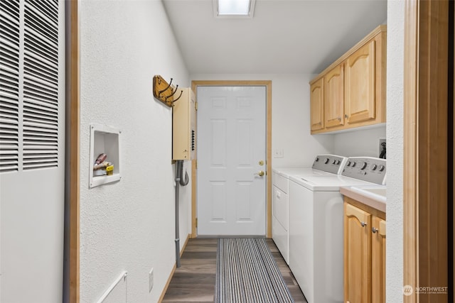 clothes washing area with dark hardwood / wood-style flooring, cabinets, and separate washer and dryer