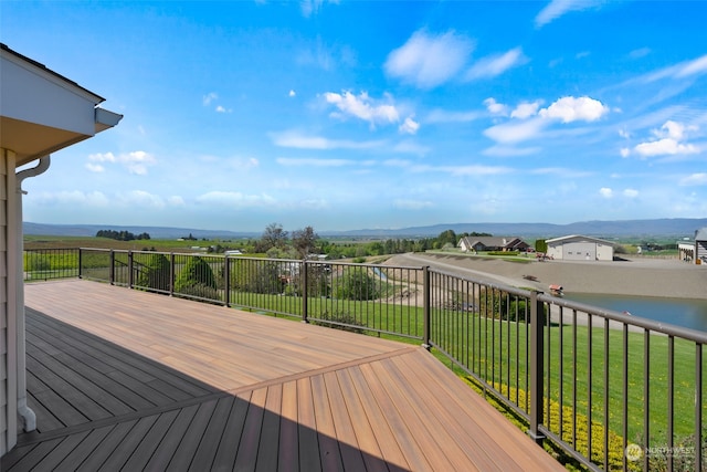 wooden deck featuring a lawn