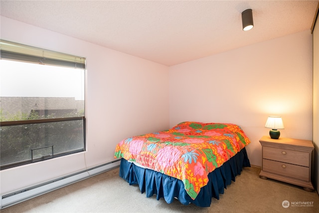 carpeted bedroom featuring a baseboard radiator