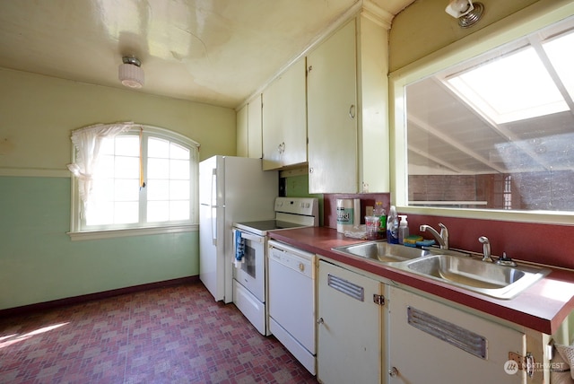 kitchen with sink, dishwasher, light tile floors, and white cabinetry