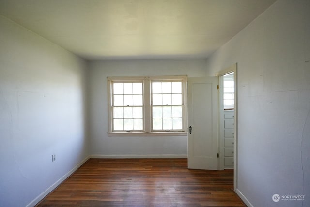 empty room with dark hardwood / wood-style floors