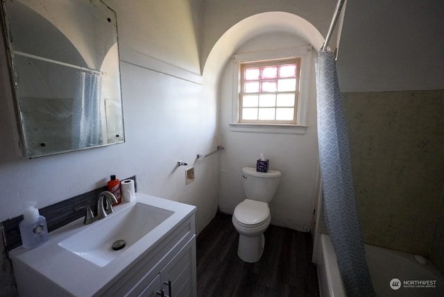 full bathroom with vanity, hardwood / wood-style flooring, toilet, and shower / bathtub combination with curtain