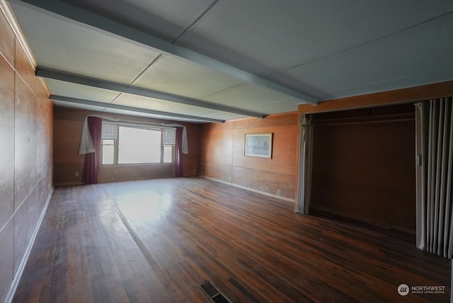 interior space featuring beam ceiling and dark hardwood / wood-style floors