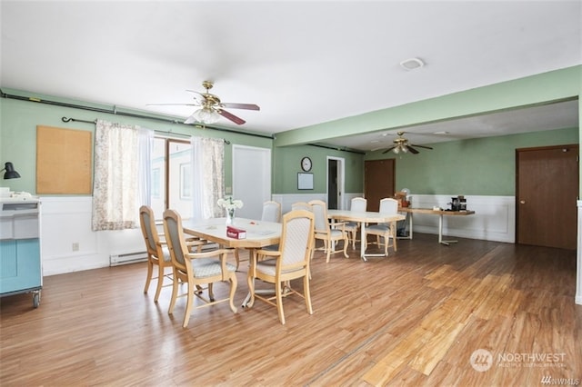 dining area with a baseboard radiator, hardwood / wood-style floors, and ceiling fan