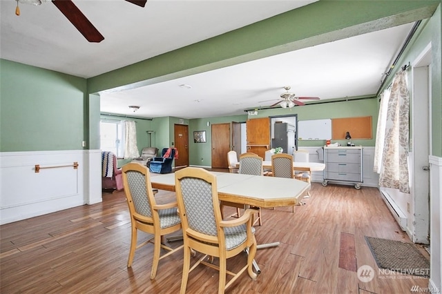 dining space featuring hardwood / wood-style flooring and ceiling fan