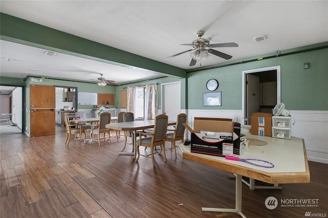 dining area with wood-type flooring and ceiling fan