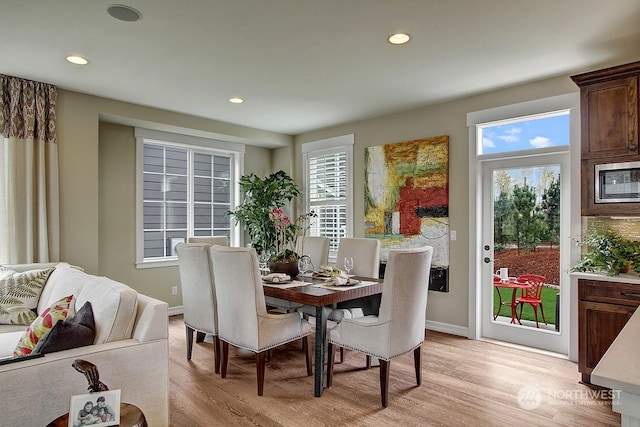 dining room with plenty of natural light and light hardwood / wood-style floors