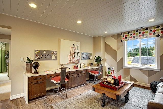 home office featuring light wood-type flooring, built in desk, and wood ceiling