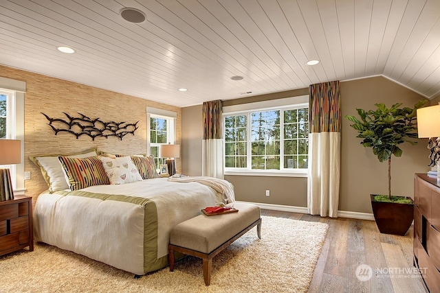 bedroom with vaulted ceiling, wood ceiling, and light hardwood / wood-style flooring