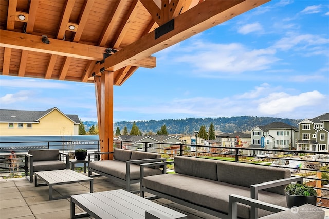 view of patio / terrace featuring outdoor lounge area, a mountain view, and a balcony