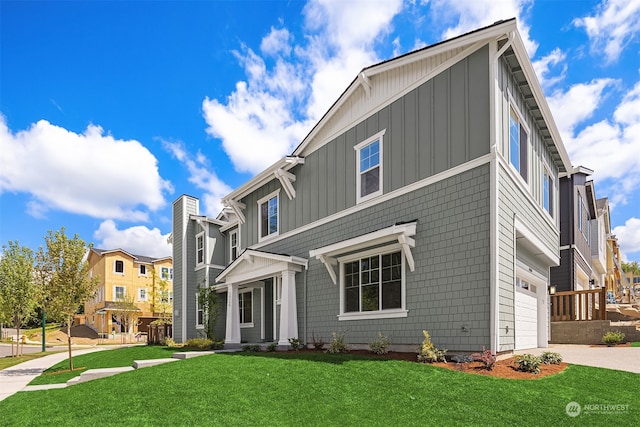 view of front of house with board and batten siding, a residential view, concrete driveway, and a front lawn