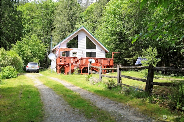 view of front facade with a deck and a front yard