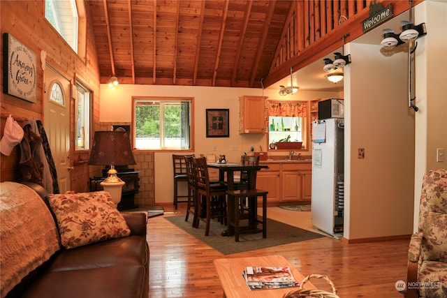 living room featuring light hardwood / wood-style floors, sink, high vaulted ceiling, and wooden ceiling