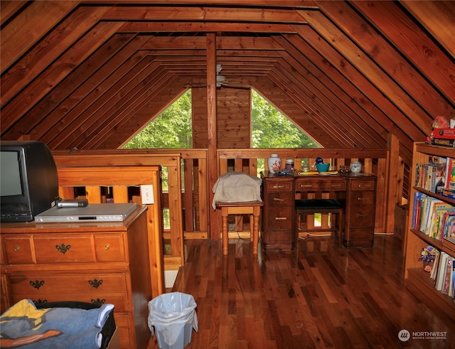 bedroom with wooden walls, vaulted ceiling, and hardwood / wood-style flooring