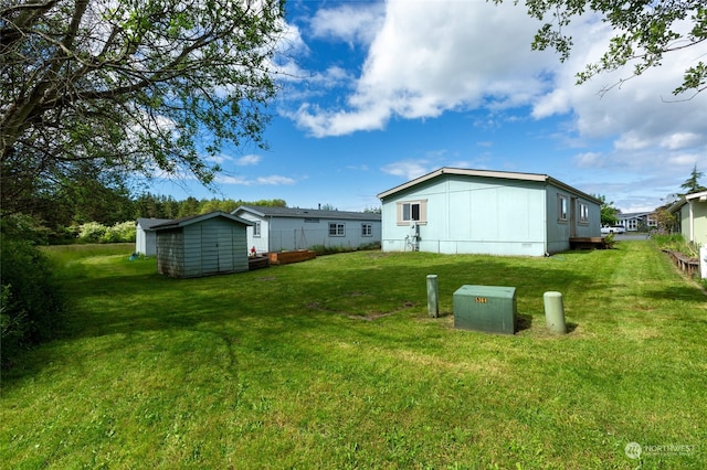 view of yard featuring an outbuilding and a shed