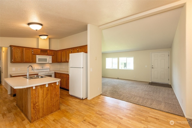 kitchen with light countertops, lofted ceiling, brown cabinetry, white appliances, and a sink