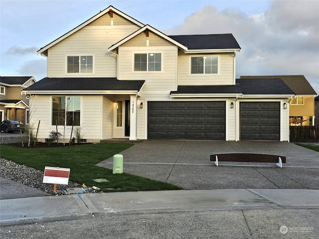 view of front of property with a front lawn and a garage