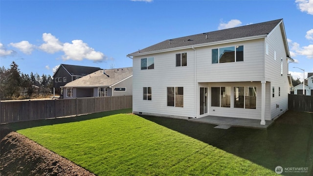 rear view of house with a lawn and a patio area