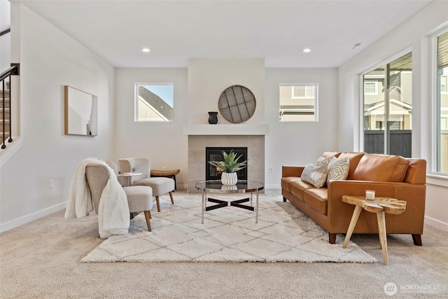 carpeted living room featuring a fireplace