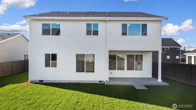 back of house featuring a patio and a lawn