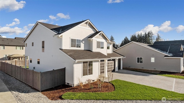 view of property featuring a garage and a front yard