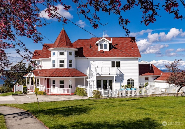 back of property featuring a porch and a lawn