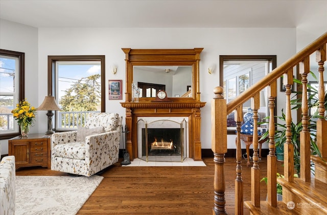 living room featuring a premium fireplace and hardwood / wood-style floors