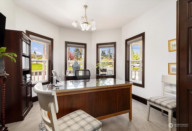 carpeted office featuring a healthy amount of sunlight and an inviting chandelier