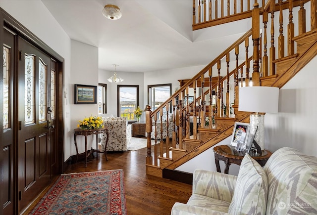 entrance foyer featuring a notable chandelier and dark hardwood / wood-style floors