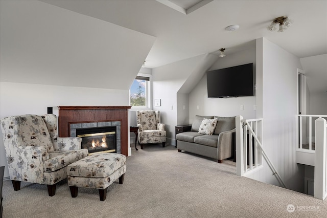 interior space with carpet floors, a fireplace, and vaulted ceiling