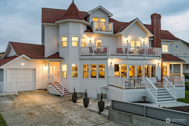 view of front of house featuring a garage and a balcony