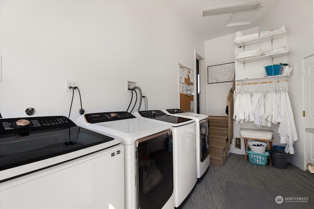 laundry room featuring hookup for an electric dryer, washer hookup, dark carpet, and washing machine and clothes dryer