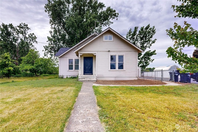 bungalow-style house with a front lawn