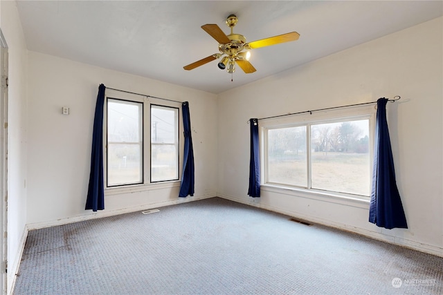 unfurnished room featuring ceiling fan and carpet floors