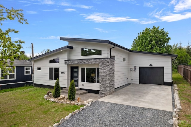 contemporary home with a garage and a front yard