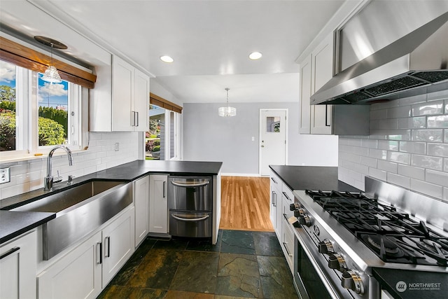 kitchen featuring dark hardwood / wood-style flooring, high end stove, white cabinetry, and wall chimney exhaust hood