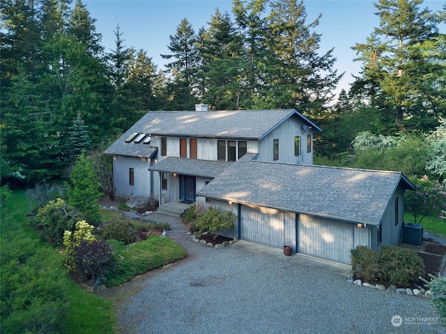 view of front of house with a garage and central AC unit