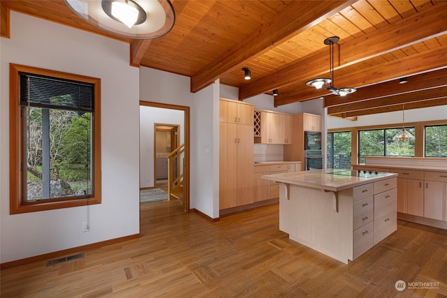 kitchen with a kitchen island, black appliances, beam ceiling, wood ceiling, and pendant lighting