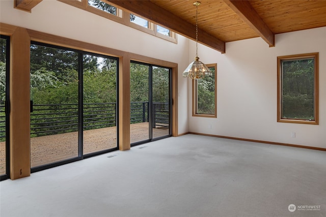 carpeted spare room featuring beam ceiling, wood ceiling, and an inviting chandelier