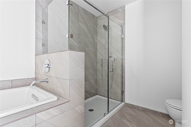 bathroom with shower with separate bathtub, toilet, and tile patterned flooring