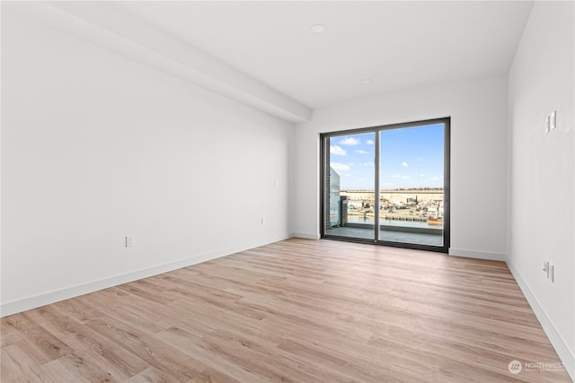 empty room with light hardwood / wood-style floors