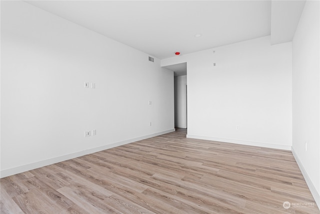 empty room with light hardwood / wood-style floors