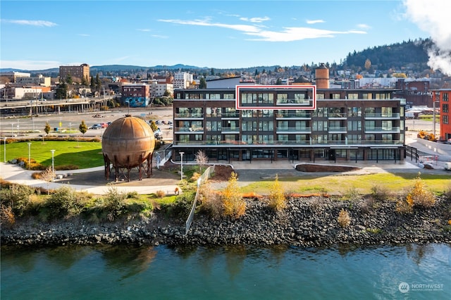 exterior space with a water and mountain view