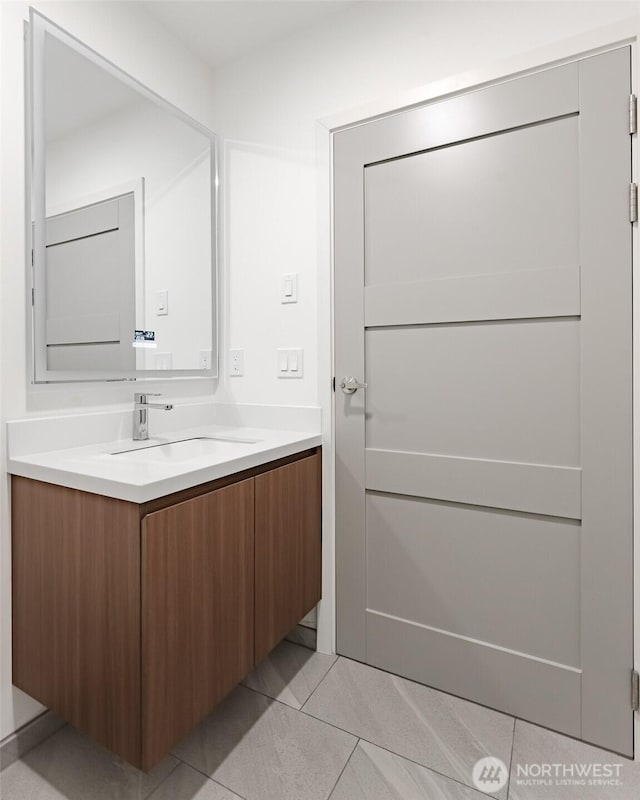 bathroom featuring tile patterned flooring and vanity