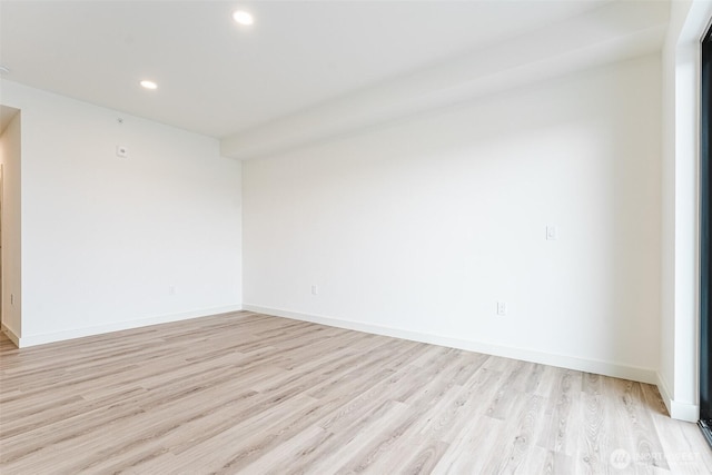 empty room with recessed lighting, baseboards, and light wood finished floors