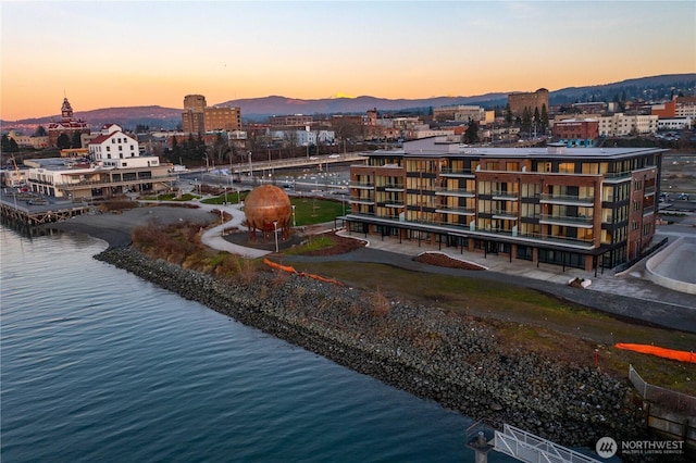 aerial view featuring a city view and a water and mountain view