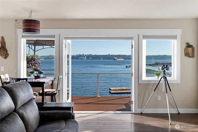 living room featuring a water view and hardwood / wood-style floors