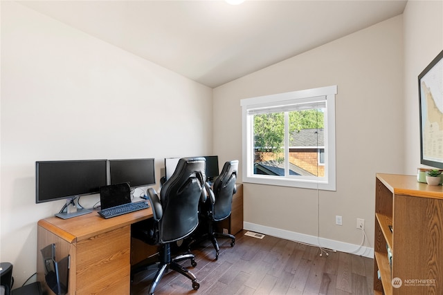 office area with dark wood-type flooring and vaulted ceiling