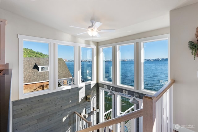 interior space featuring plenty of natural light and a water view